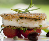 Sea bass baked in molche bread with cherry tomatoes and racket