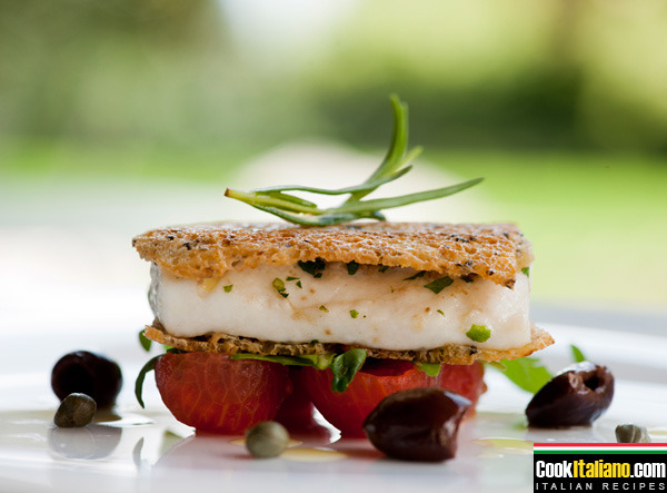 Sea bass baked in molche bread with cherry tomatoes and racket